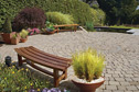 Bespoke garden furniture and container planting add comfort and elegance to the garden.