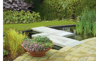 Large patio with wrap-around pond water feature gives the garden plan a contemporary feel.